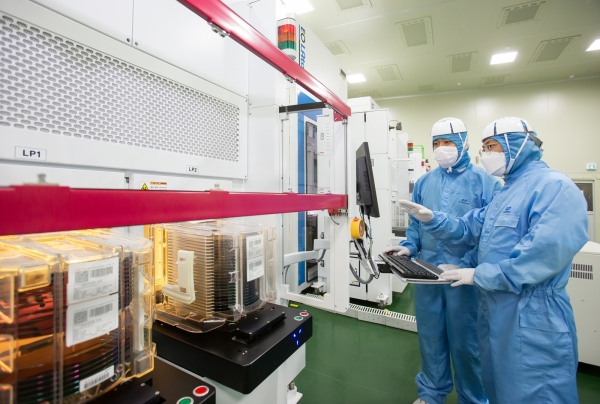 삼성전자와 이오테크닉스 직원이 양사가 공동 개발한 반도체 레이저 설비를 함께 살펴보고 있다.